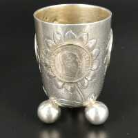 Pair of antique silver coin cups on ball feet