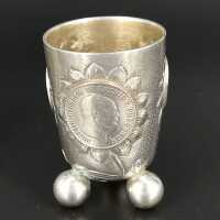 Pair of antique silver coin cups on ball feet