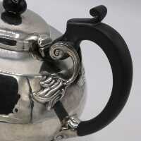 Antique silver tea service in Arts and Crafts style