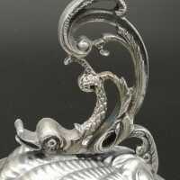 A pair of exquisite silver candlesticks with dolphin figures