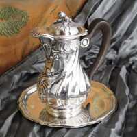 Miniature silver coffe pot with wooden handle and saucer...