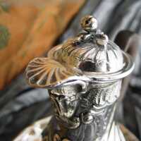 Miniature silver coffe pot with wooden handle and saucer...