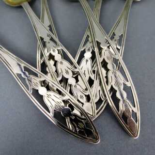 A set of six dessert spoons silver and gold