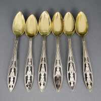 A set of six dessert spoons silver and gold