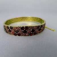 Antique bangle with rolled gold and deep red flat garnets