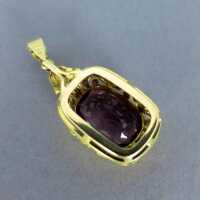 Charming open worked 14 k gold pendant with deep violett amethyst stone 