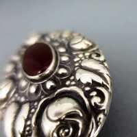 Art Nouveau silver brooch with carnelian cabochon and repusse roses decoration 
