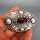 Art Nouveau silver brooch with carnelian cabochon and repusse roses decoration 