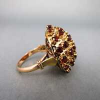 Wonderful ladys cluster ring open worked in gold with dark red tourmaline