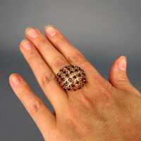 Wonderful ladys cluster ring open worked in gold with dark red tourmaline