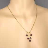 Elegant and delicate gold necklace with deep red tourmaline and box chain