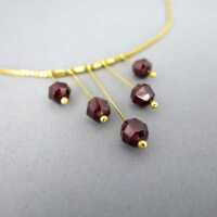 Elegant and delicate gold necklace with deep red tourmaline and box chain