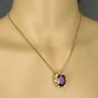Unusual and wonderful gold pendant with a deep violet amethyst and a chain
