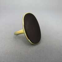 Beautiful gold ring with relief decor and a huge oval black onyx cabochon slice