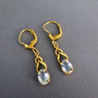 Long dangling earrings in gold with natural light blue aquamarine