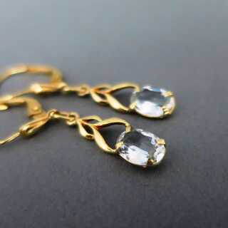 Long dangling earrings in gold with natural light blue aquamarine