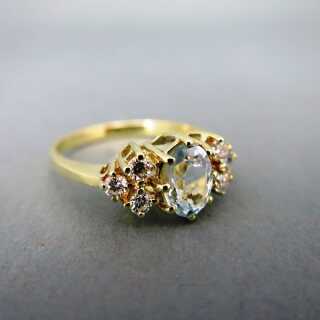 Sparkly woman ring in gold with natural blue aquamarine and diamonds