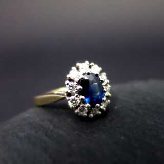 Elegant woman ring in white gold with blue sapphire and sparkly diamonds