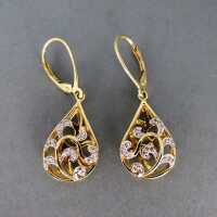 Gorgeous open worked drop shaped dangling earrings in gold with diamonds