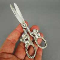 Antique silver scissors with rich putto and flowers...