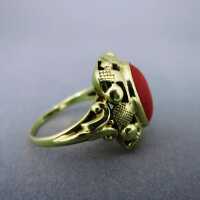 Rich decorated 14 k gold ring with an oval red coral cabochon Wilheml Müller