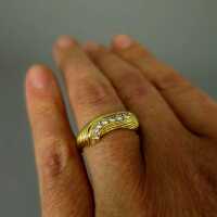 Interesting abstract shaped ladies gold ring with numerous diamonds