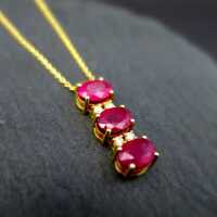 Modern pendant in 14 k gold with rubies and diamonds incl. chain