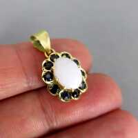 Charming gold pendant with genuine white opal cabochon and deep blue sapphire