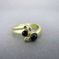 Beautiful ladys ring in gold with blue sapphires and sparkly diamonds