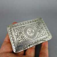 Antique small pill box in silver and gold with rich floral pattern and monogram