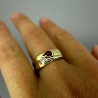 Elegant two tone 18 k gold ladys band ring with ruby drop and a sparkly diamond 