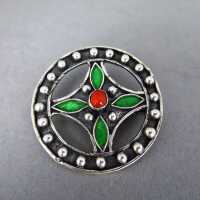 Round open worked silver brooch with red coral and green...