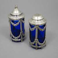 Antique salt and pepper shakers made of silver with royal blue glass inserts