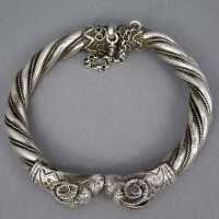 Exceptional silver bangle with two ram heads around 1880