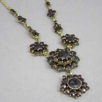 Magnificent necklace in floral design studded with deep red garnet