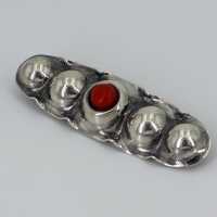 Antique, long oval silver brooch set with a coral