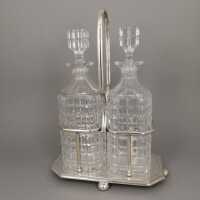 A pair of rare English whiskey bottles with holders from...