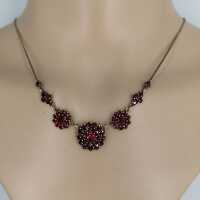 Magnificent necklace in a floral design set with deep red garnet