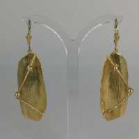 Modern earrings in gold in an abstract form