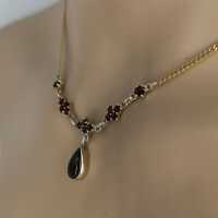 Beautiful delicate gold necklace with garnet stones