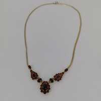Beautiful gold necklace with red garnet stones including...