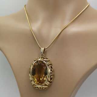 Large pendant in gold with a large straw yellow noble topaz