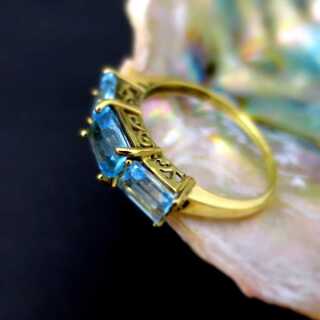 Unique ladys gold ring with blue topaz baquettes open worked ring head design