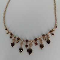 Elegant necklace in rose gold with garnet hearts and pearls