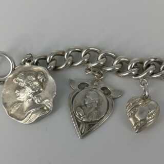 Charm bracelet in silver with many individual pendants around 1900