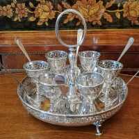 Set with 6 egg cups with holder and 6 teaspoons around 1910