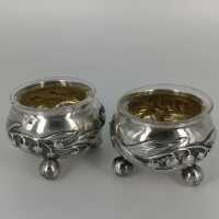 Pair of salt cellars in silver and gold with a lily of...