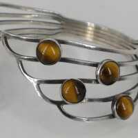 Abstract designer bangle in silver with tiger eye cabochons