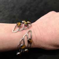 Abstract designer bangle in silver with tiger eye cabochons