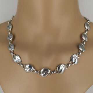 Beautiful designer necklace with abstract floral elements in solid silver
